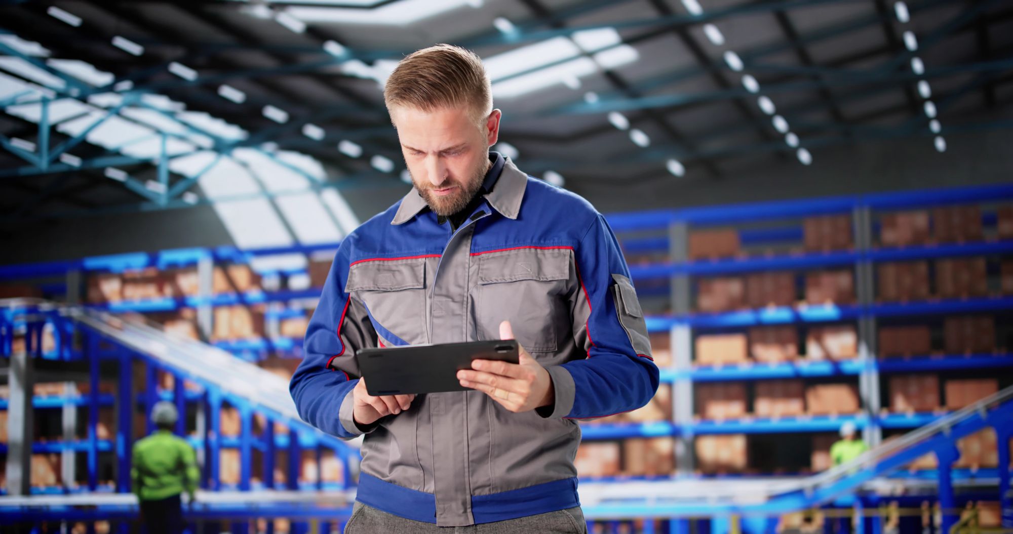 Warehouse supervisor checking a tablet in front of shelving and a conveyor